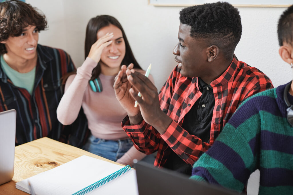 group of young diverse students learning together inside library